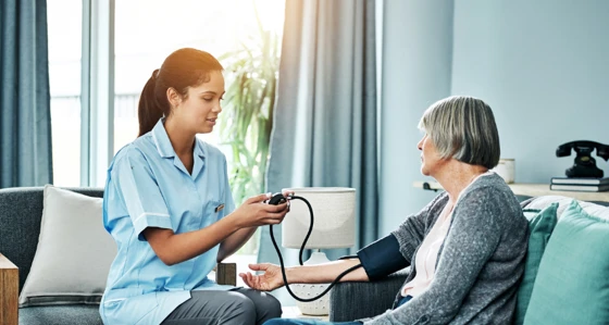 Home nurse checking a patient's blood pressure
