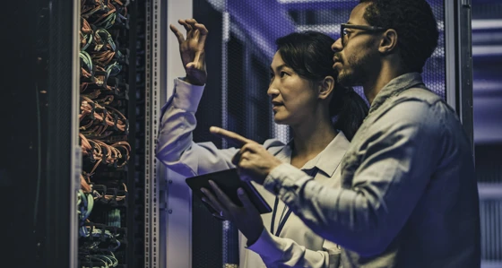 Two workers inspecting a server