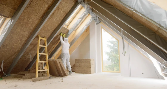 Worker retrofitting a house