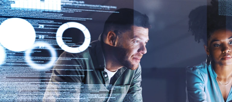 Two colleagues looking a data on a screen
