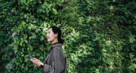 Business woman in front of trees