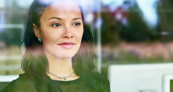 A woman staring out of an office window