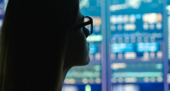A woman looking at digital screens