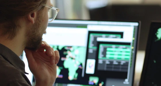 A man viewing a world map on a screen