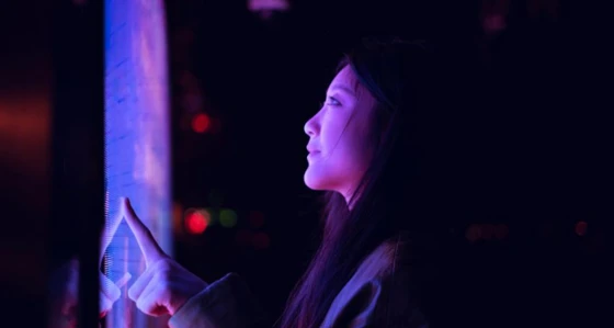 Woman looking at a purple screen