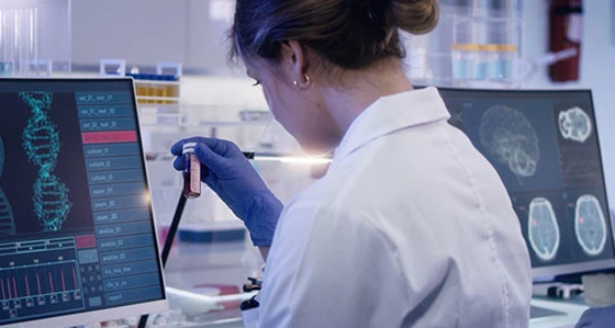 A lab technician studying a sample